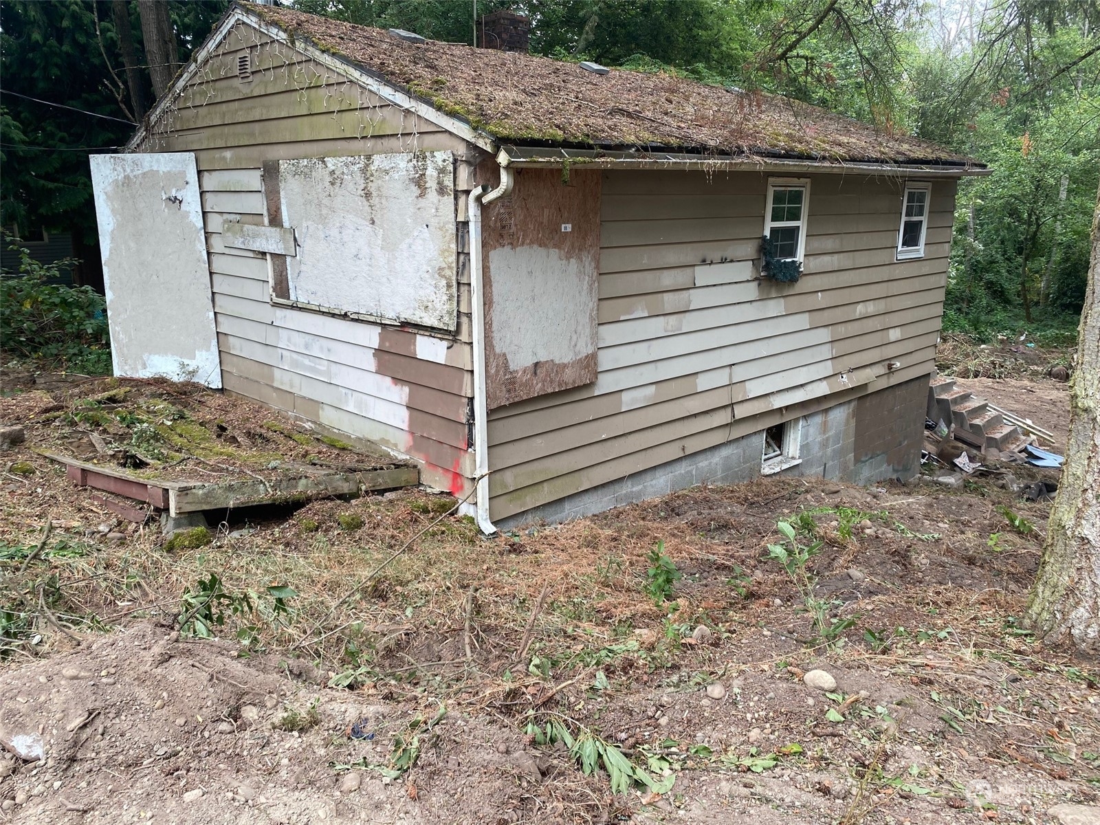 a view of a wooden house with a yard