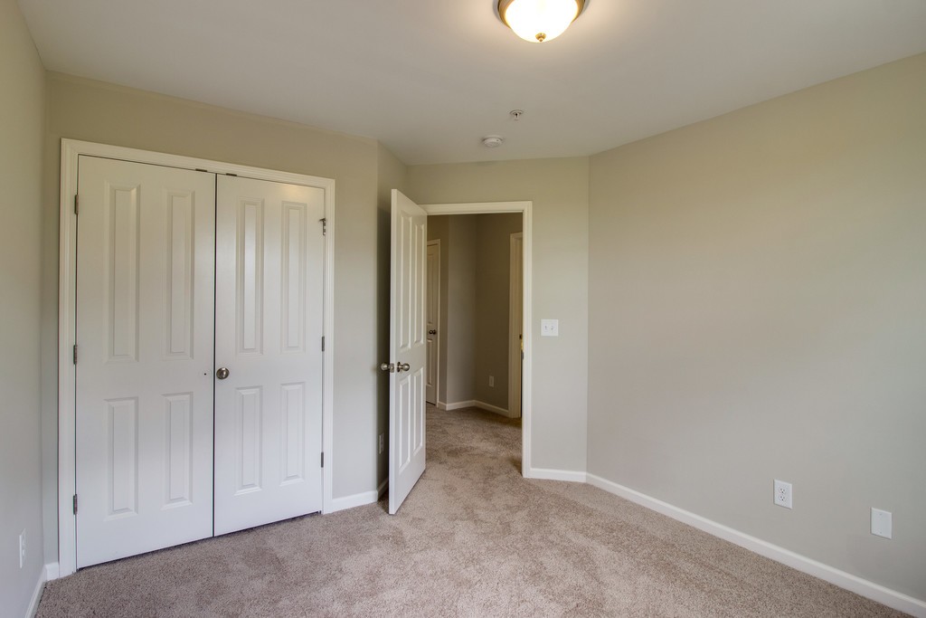 a view of an empty room with a bathroom