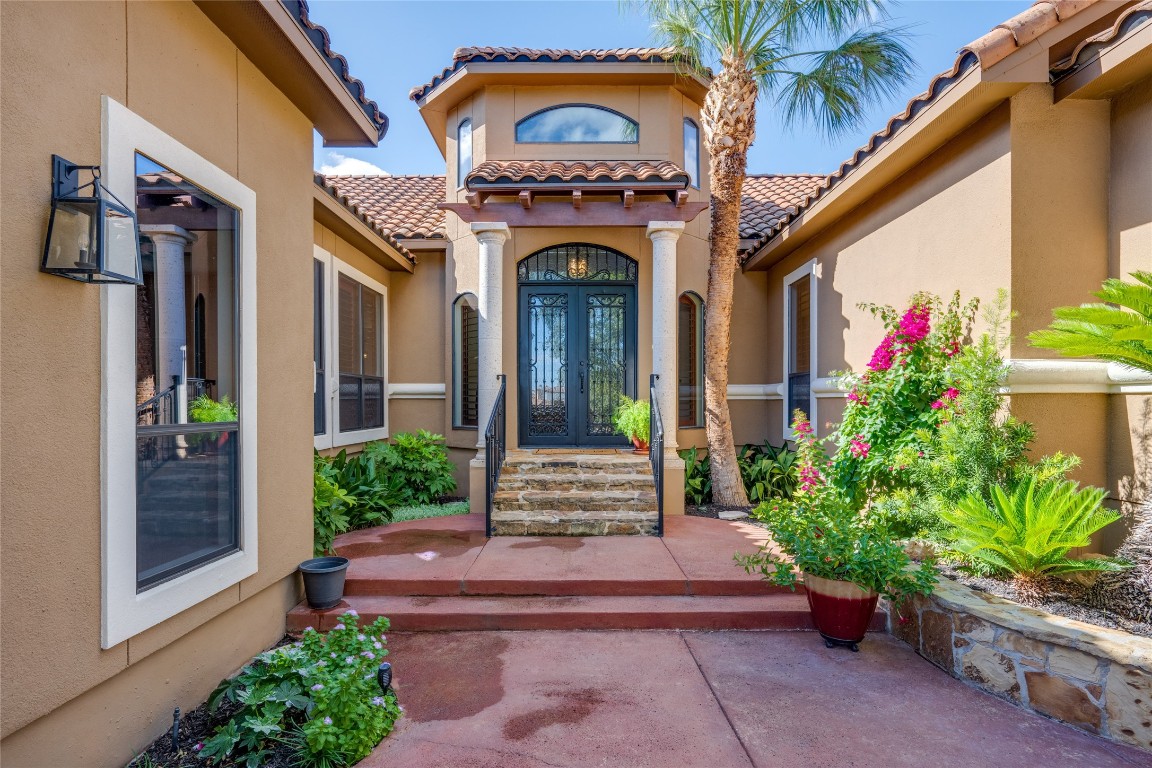 a front view of a house with plants