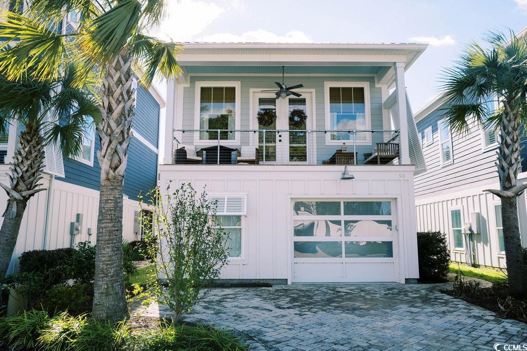 Rear view of property featuring ceiling fan, a bal