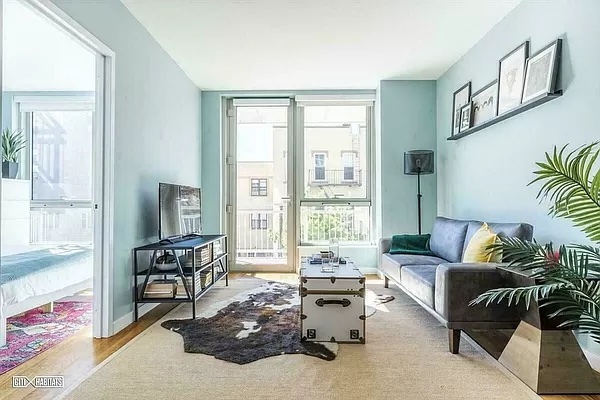 a living room with furniture and a floor to ceiling window