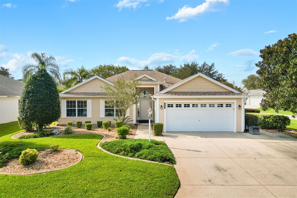 a front view of a house with a yard and garage