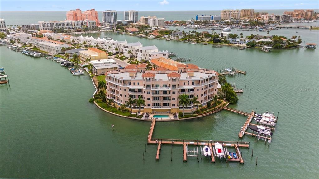 an aerial view of a house with outdoor space lake view and ocean view