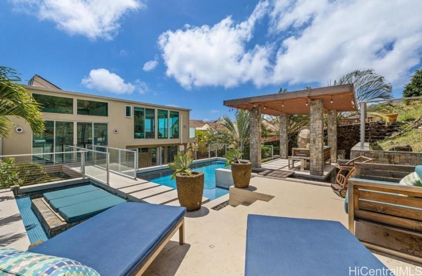 a view of a patio with couches table and chairs and potted plants