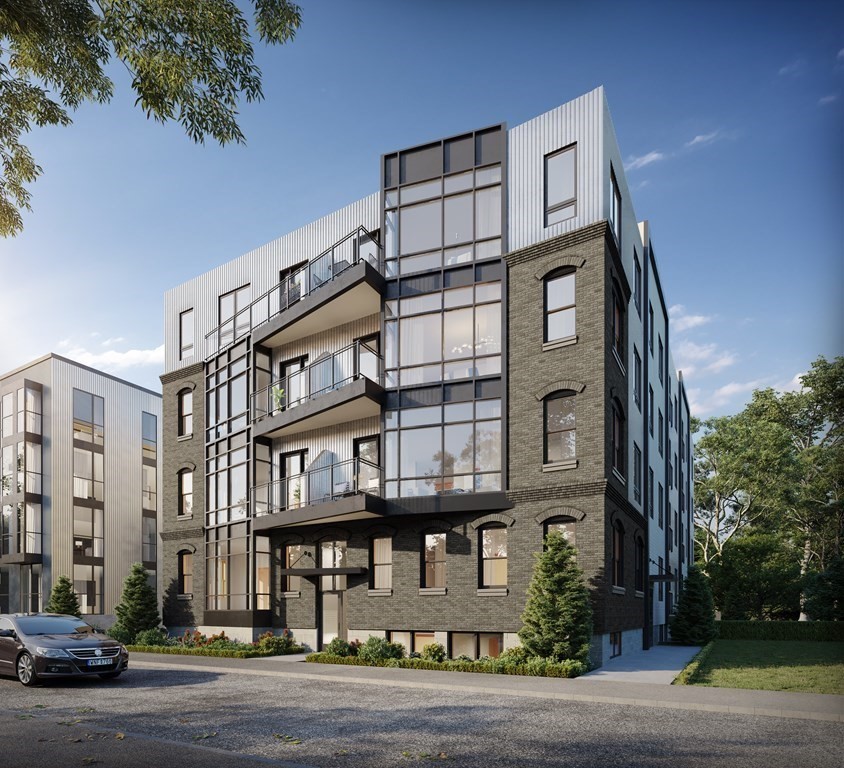 a front view of a residential apartment building with a yard