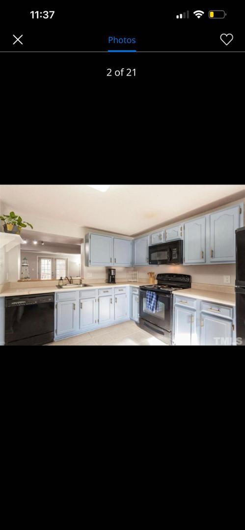 a kitchen with kitchen island sink and cabinets