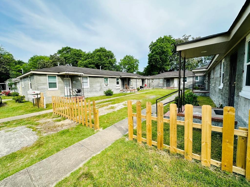 a view of a house with a yard patio and swimming pool