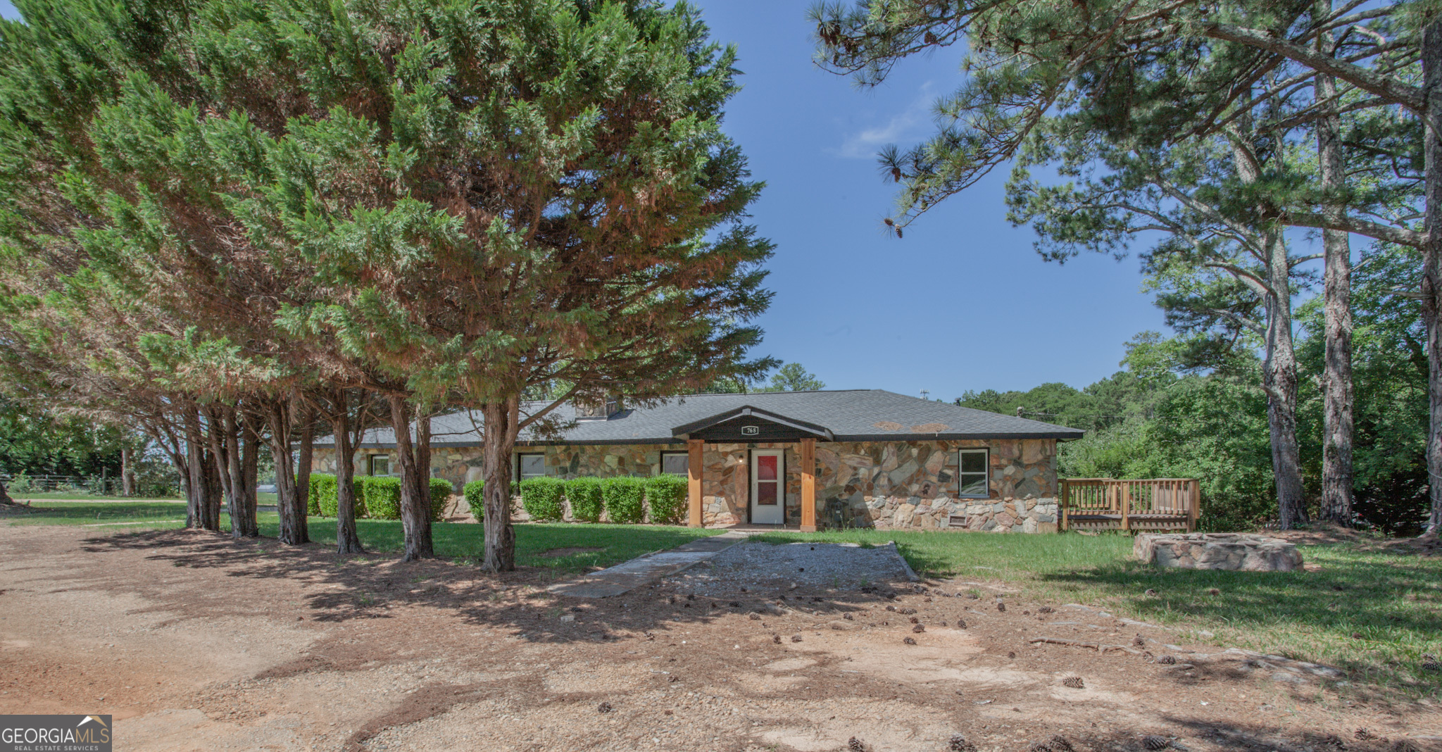 a view of a house with a yard and tree s