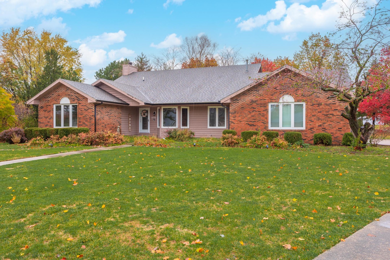 a front view of house with yard and green space