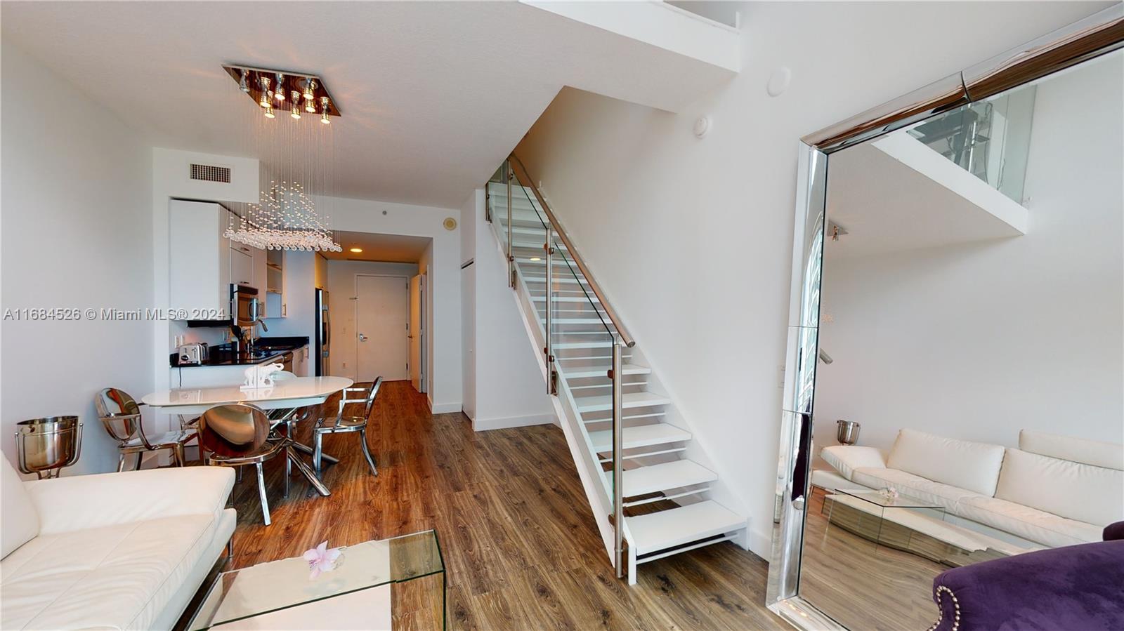 a view of a livingroom with furniture and stairs