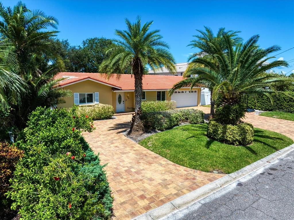 a front view of house with yard and green space