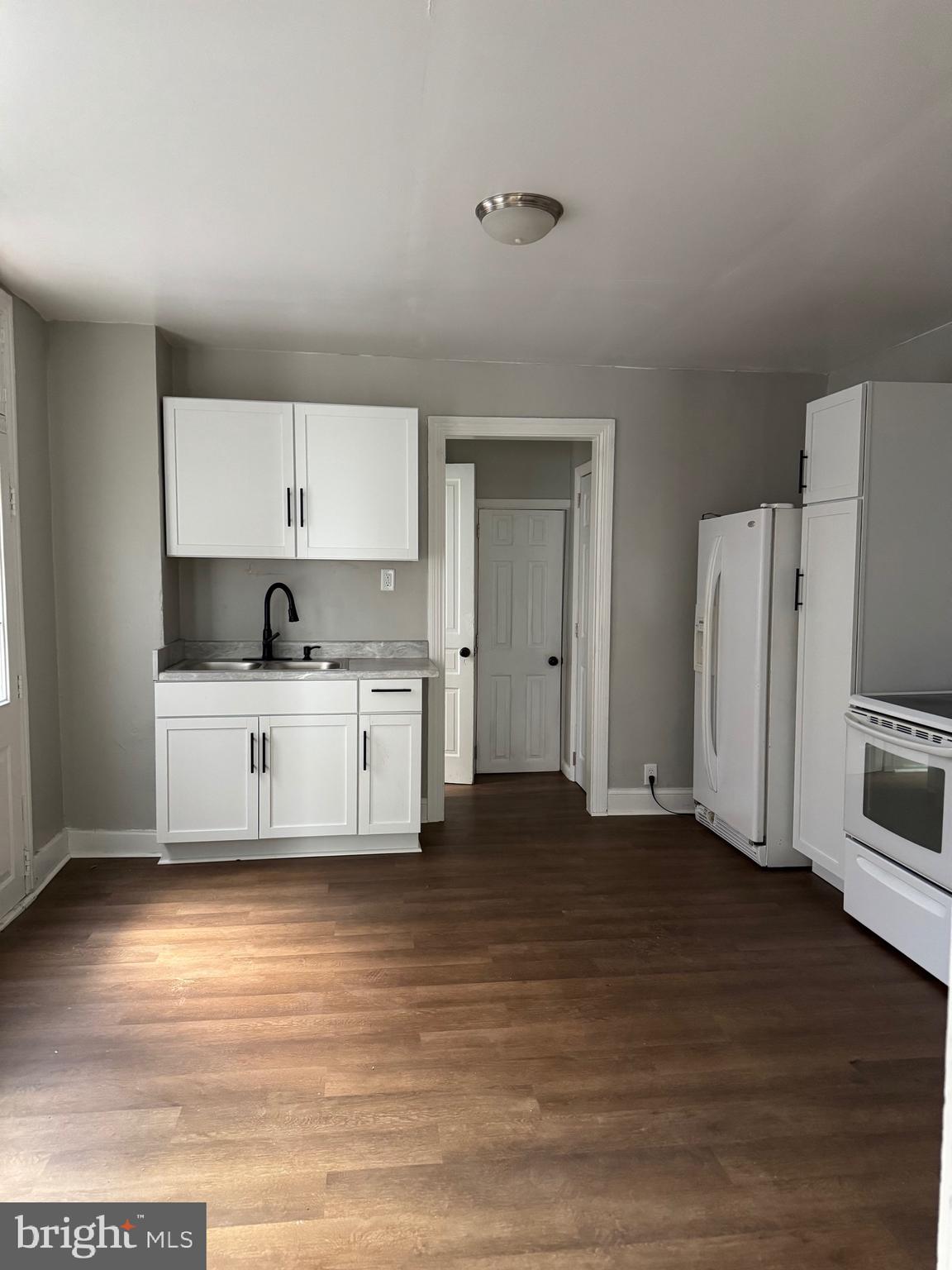 a kitchen with stainless steel appliances a refrigerator sink and cabinets