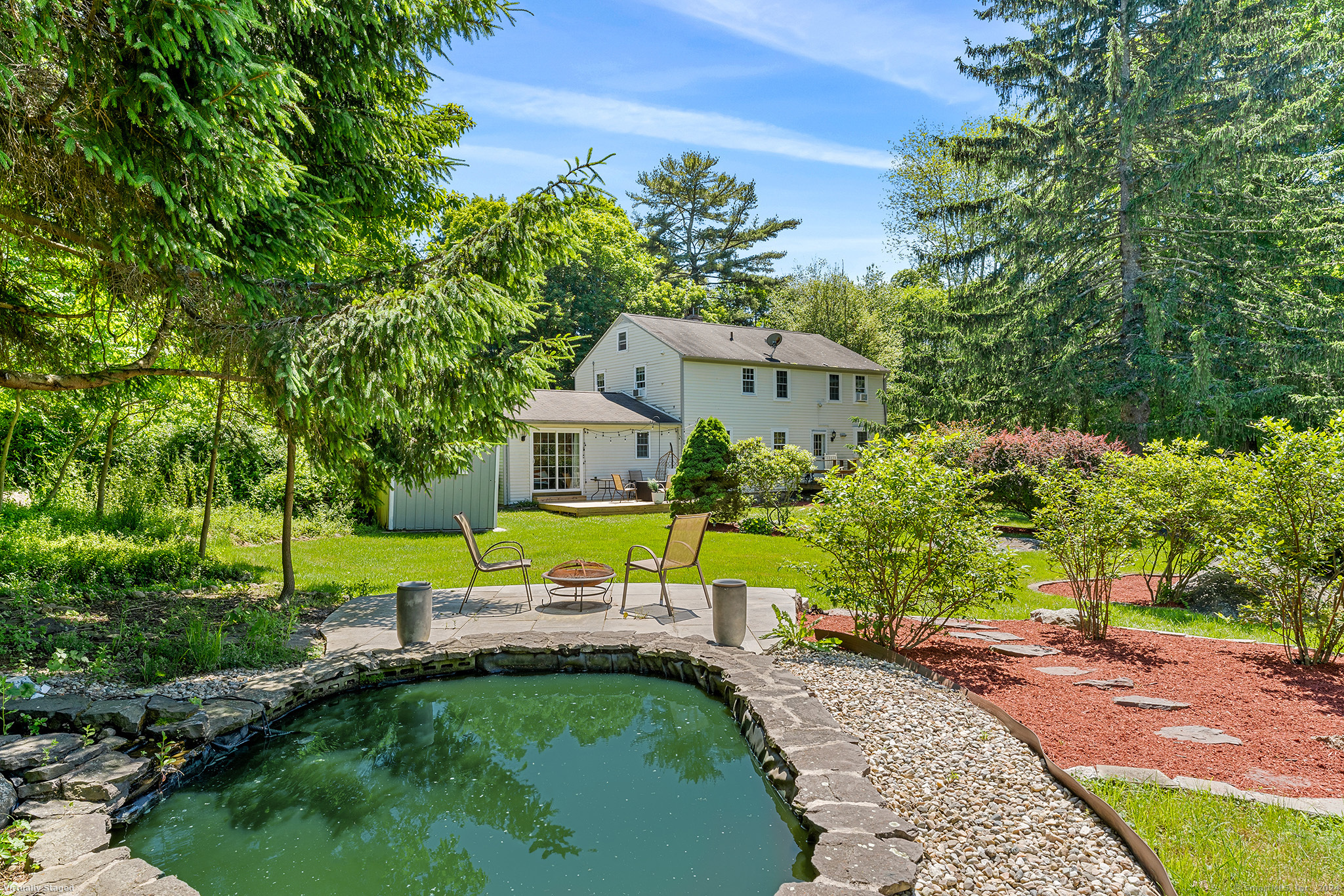 a view of a swimming pool with a yard and plants