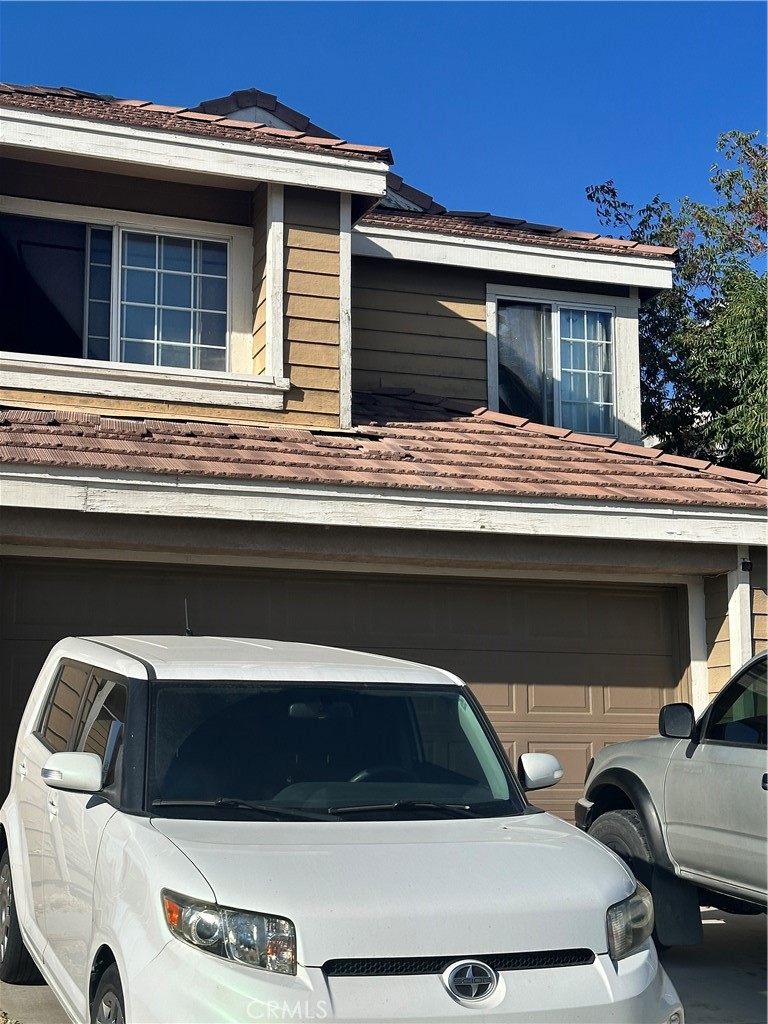 a view of house that has car parked