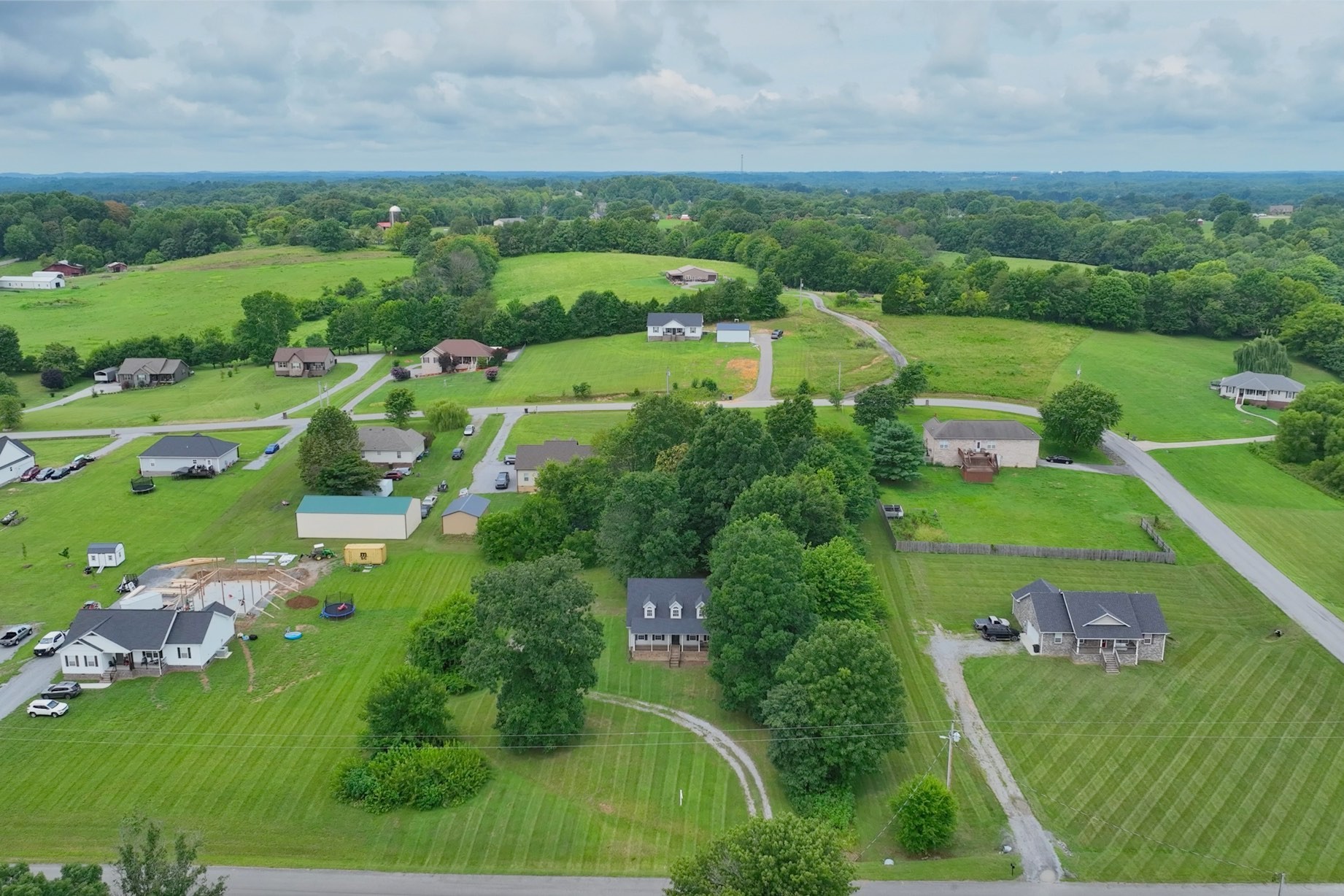 Welcome Home to 223 Lauren Ln!  Nice, two-story Country home with rocking chair front porch!  Trees around the home give you privacy!