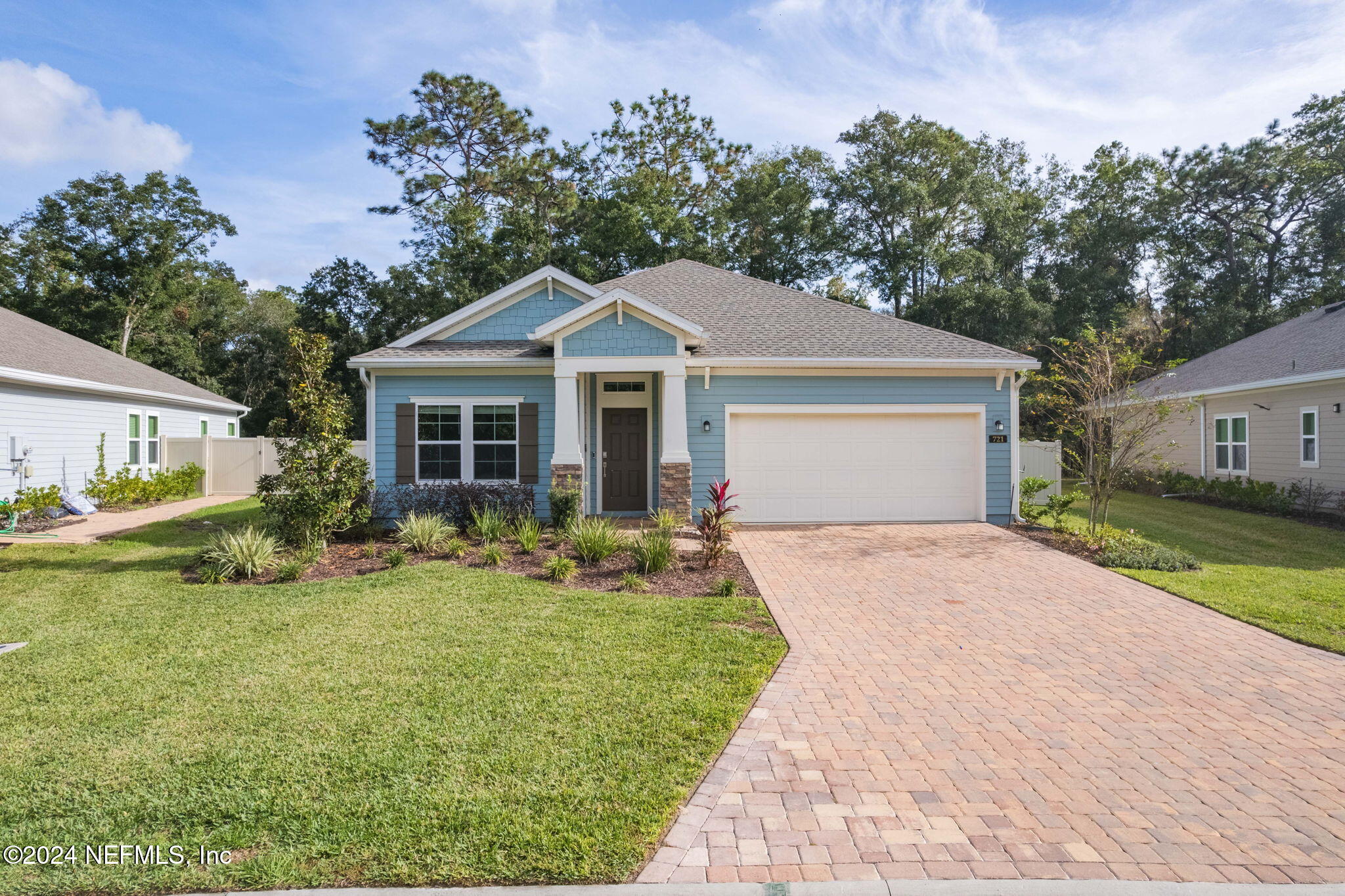 a front view of a house with a garden