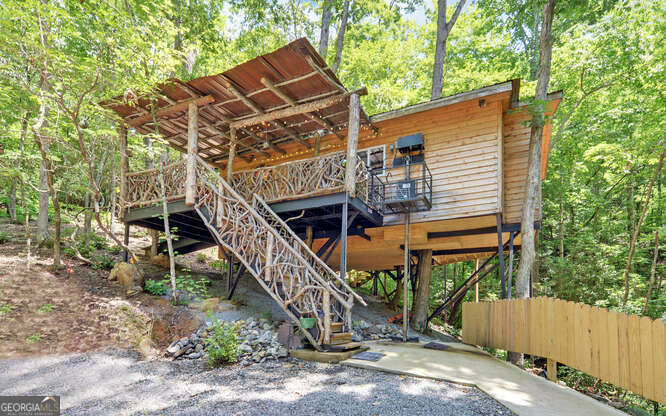 a view of a house with a yard and a wooden deck