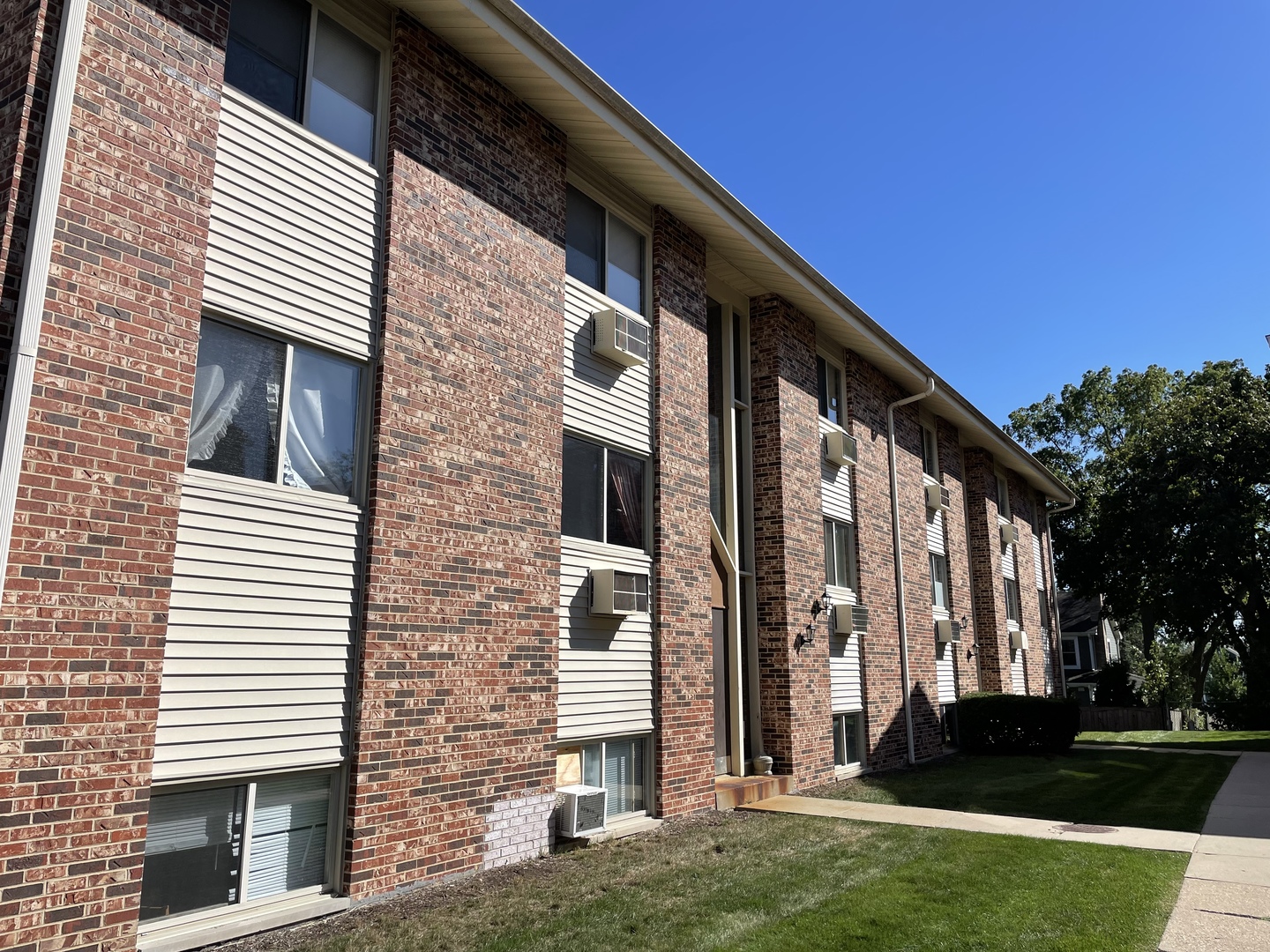 a view of a building with a yard