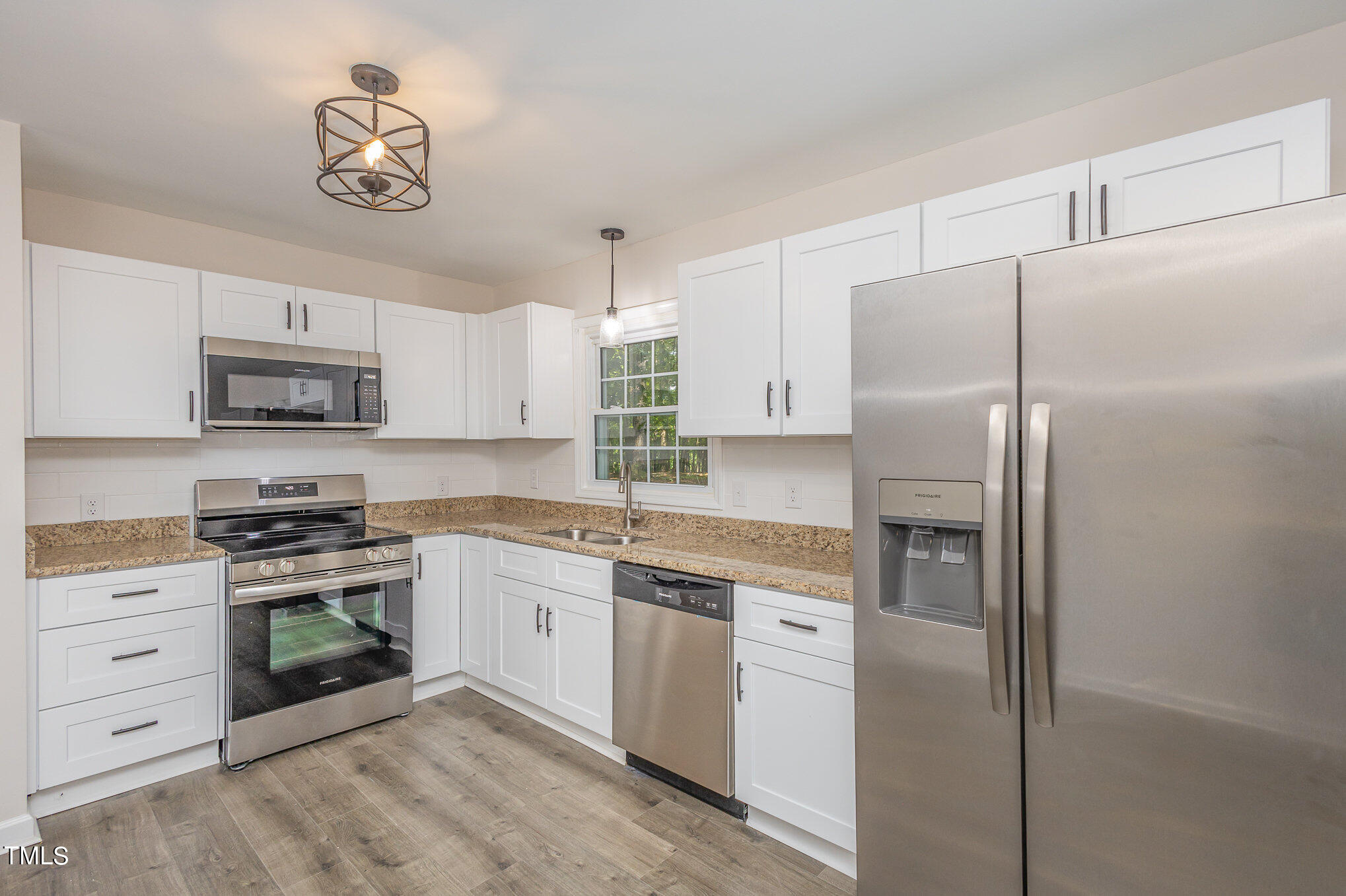 a kitchen with cabinets stainless steel appliances and a counter space