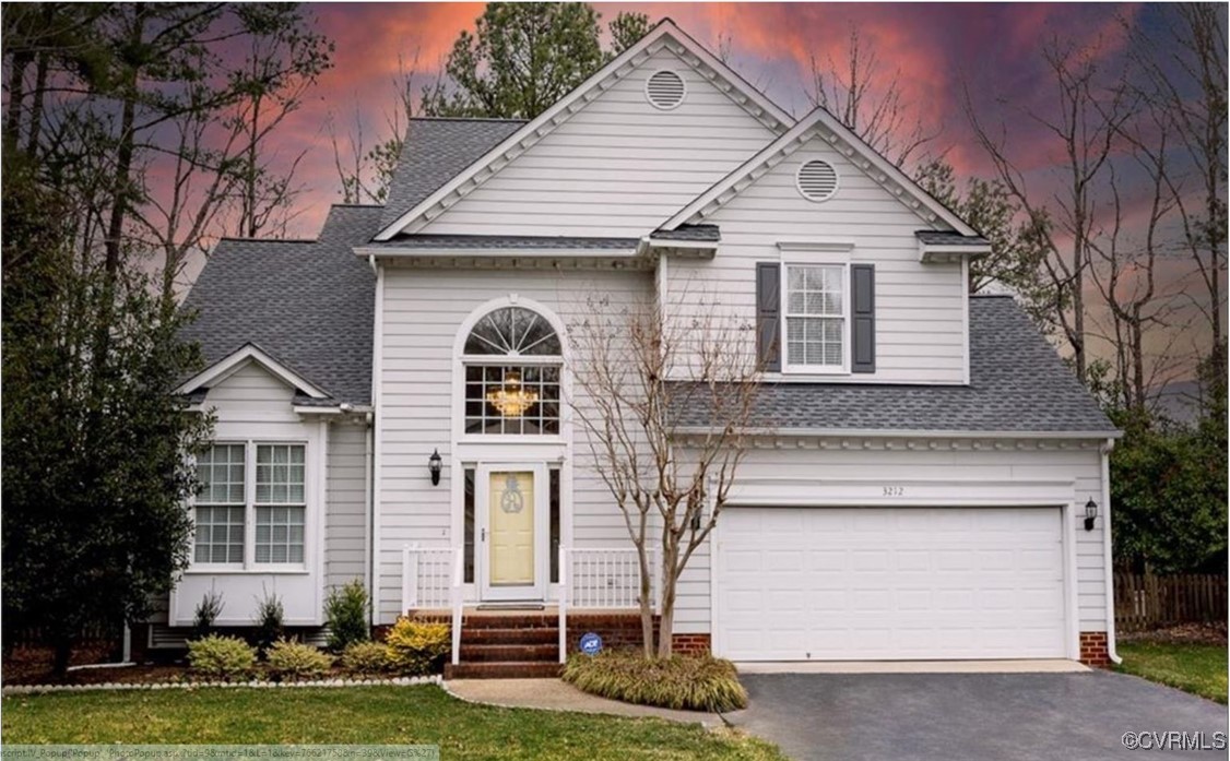 a front view of a house with a yard garage and outdoor seating