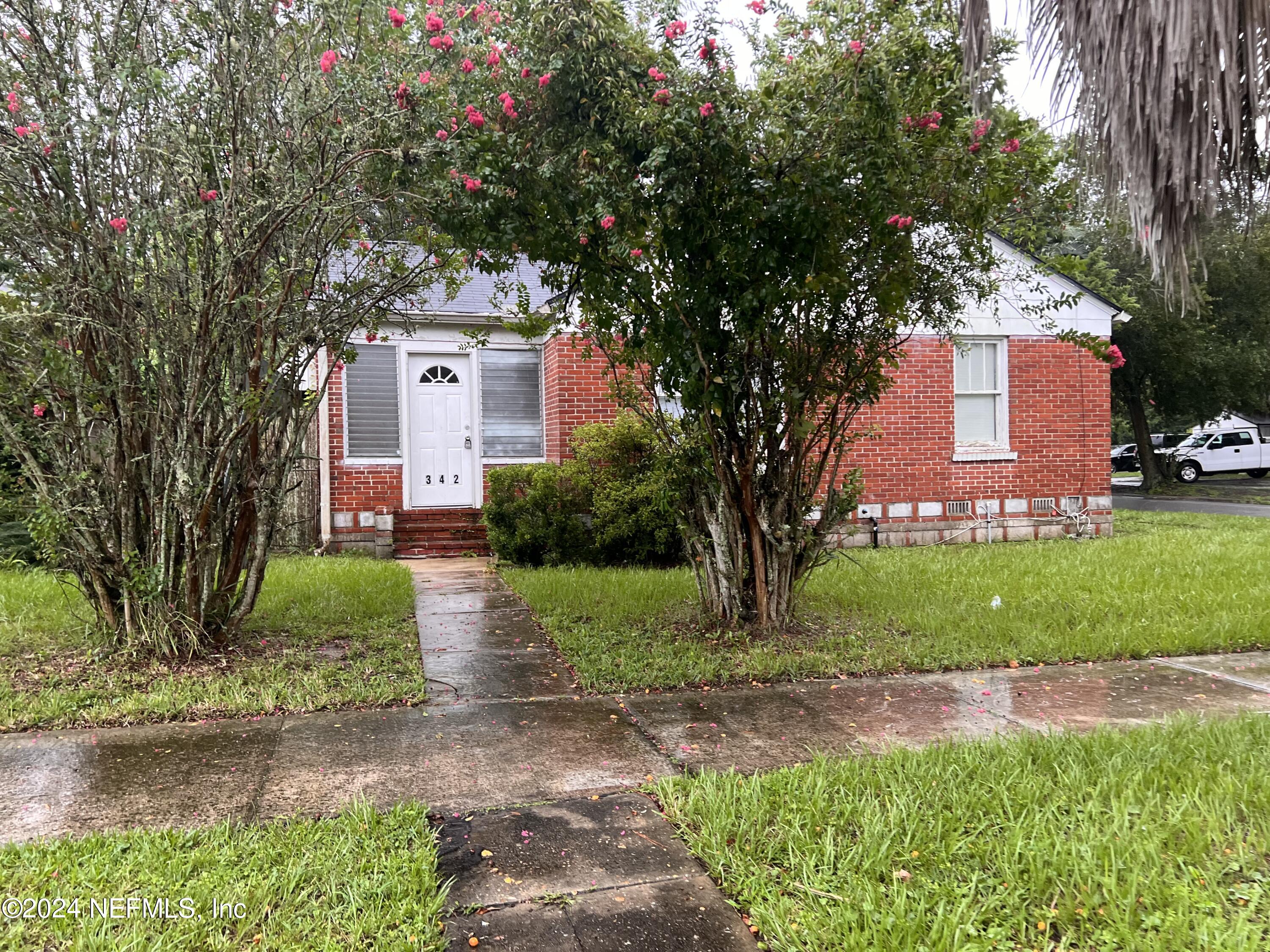 a front view of a house with garden