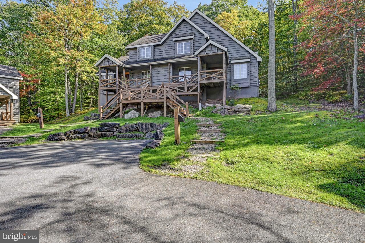 a front view of a house with yard and green space