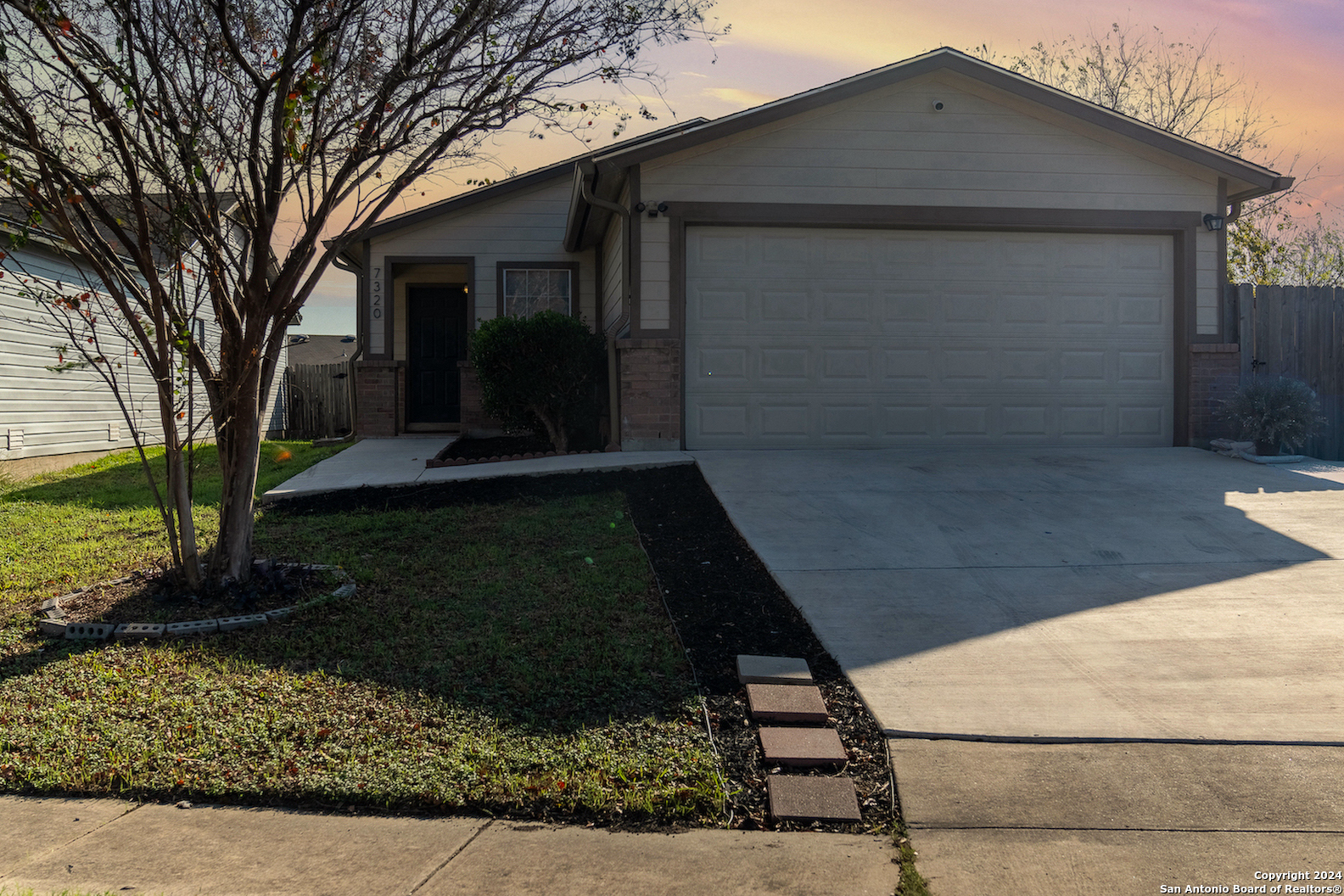 a front view of a house with garden