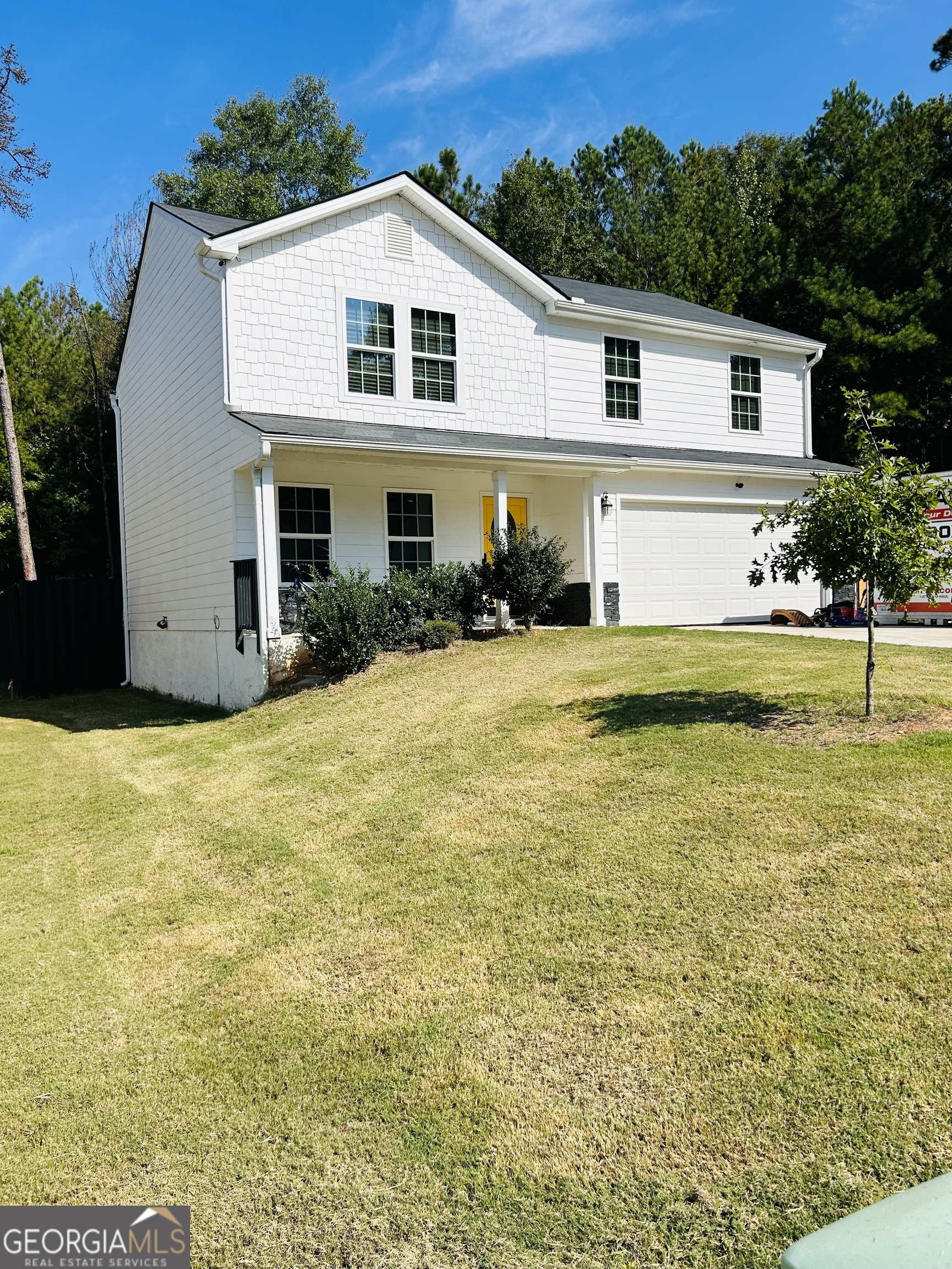 a view of a house with pool and a yard