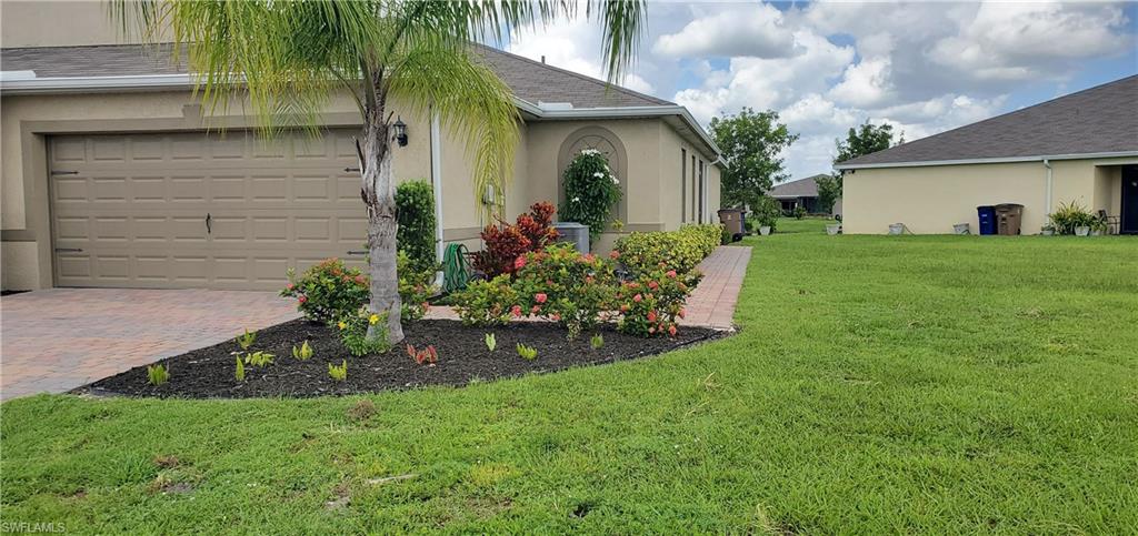 a front view of a house with a garden