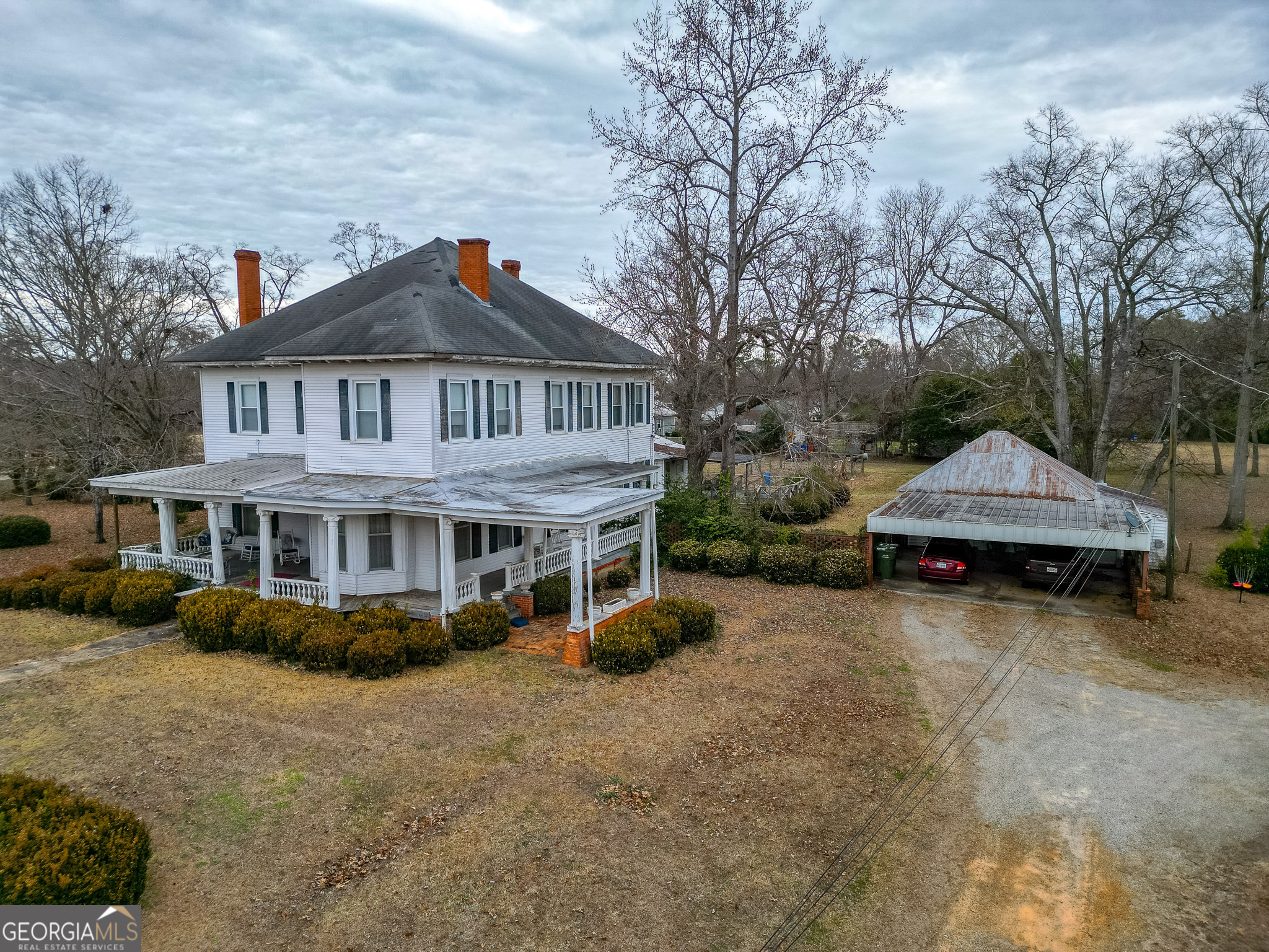 a view of a house with a yard and sitting area