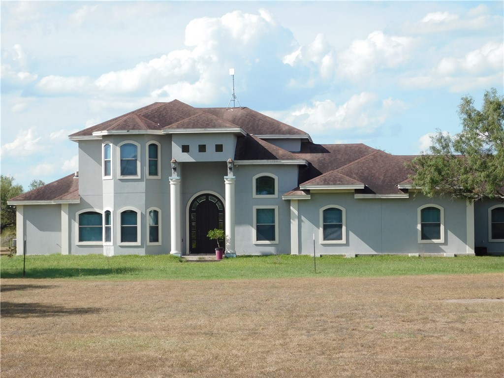 a front view of a house with a garden