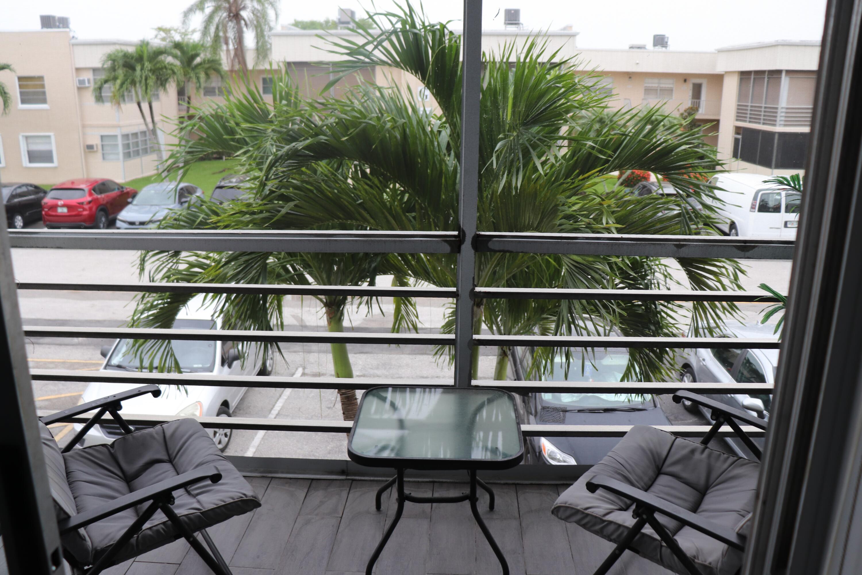 a view of a chairs and table in a balcony