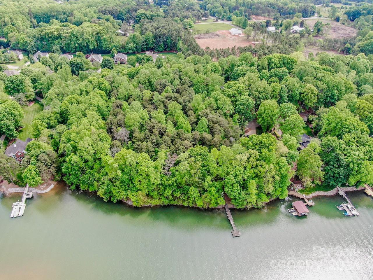 an aerial view of a house with a yard and street view