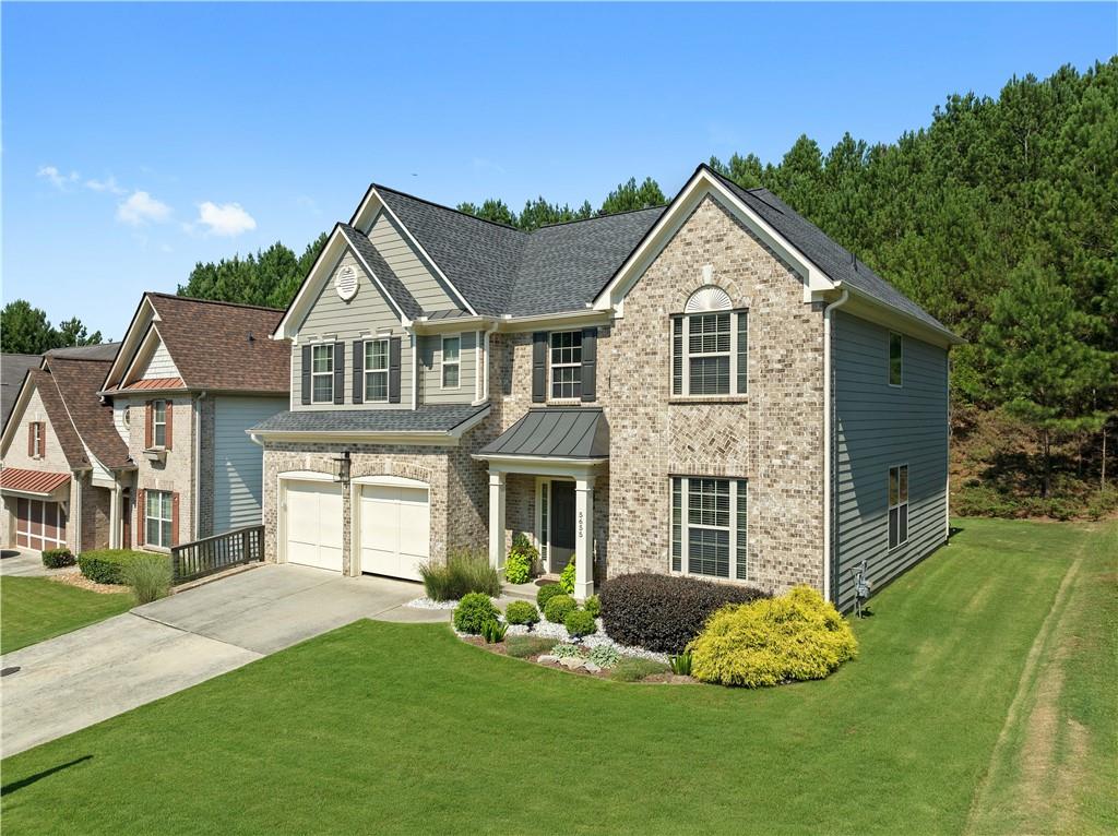 a front view of a house with a yard and porch