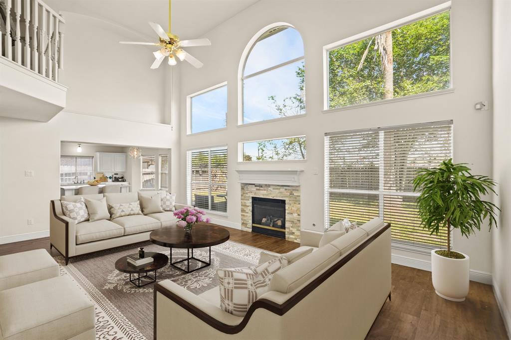 a living room with furniture large window and fireplace