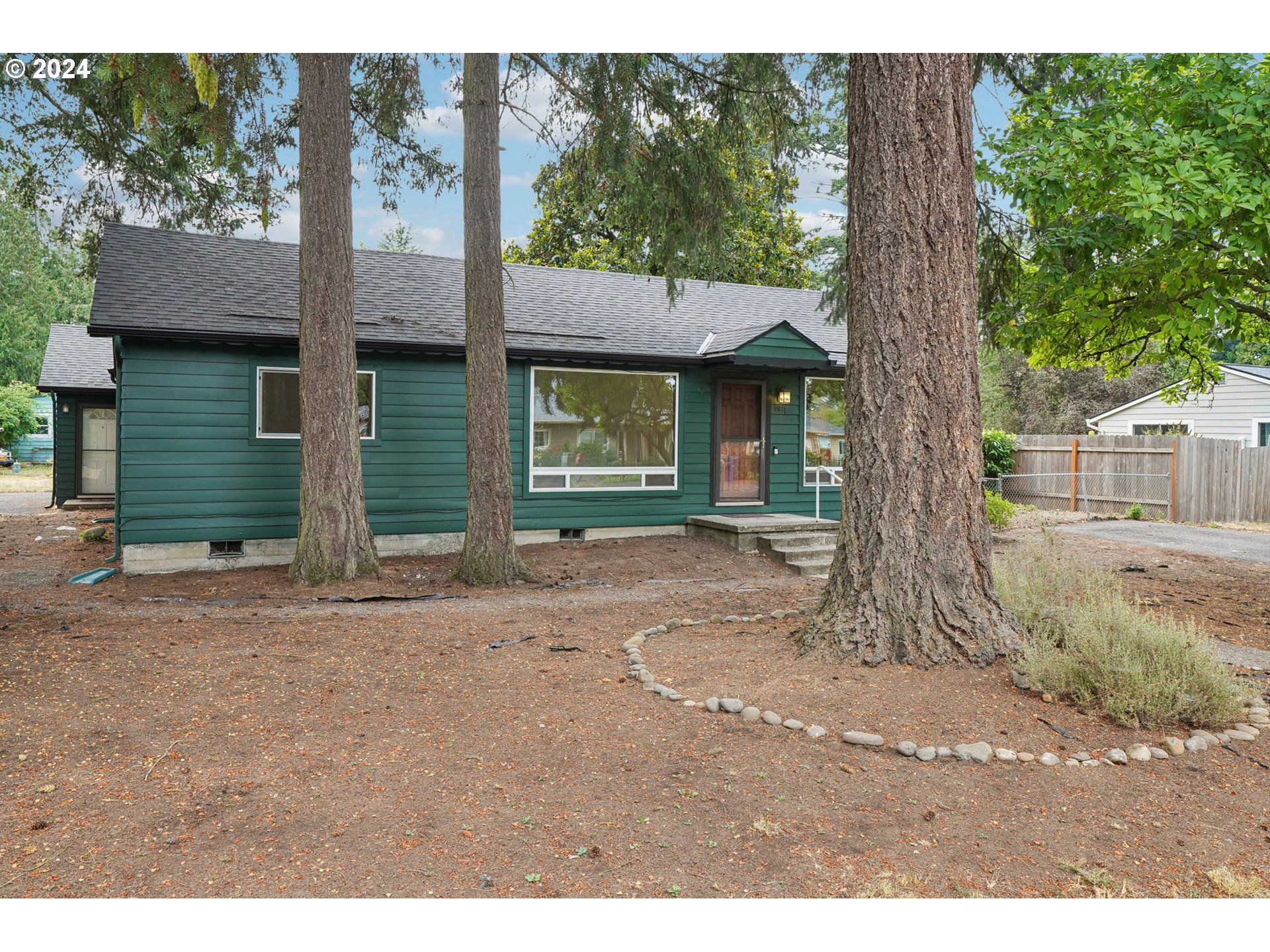 a view of a house with a tree in front