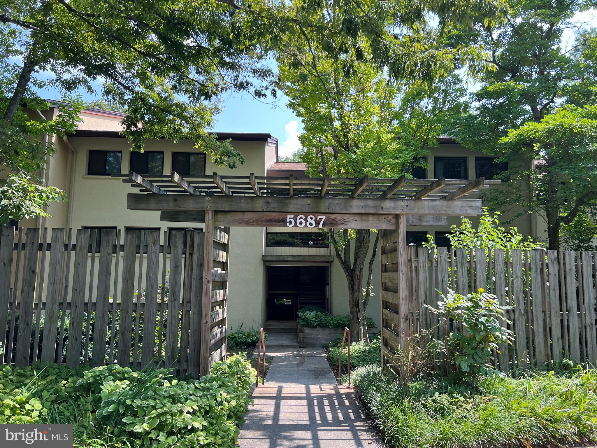 a front view of a house with yard and outdoor seating