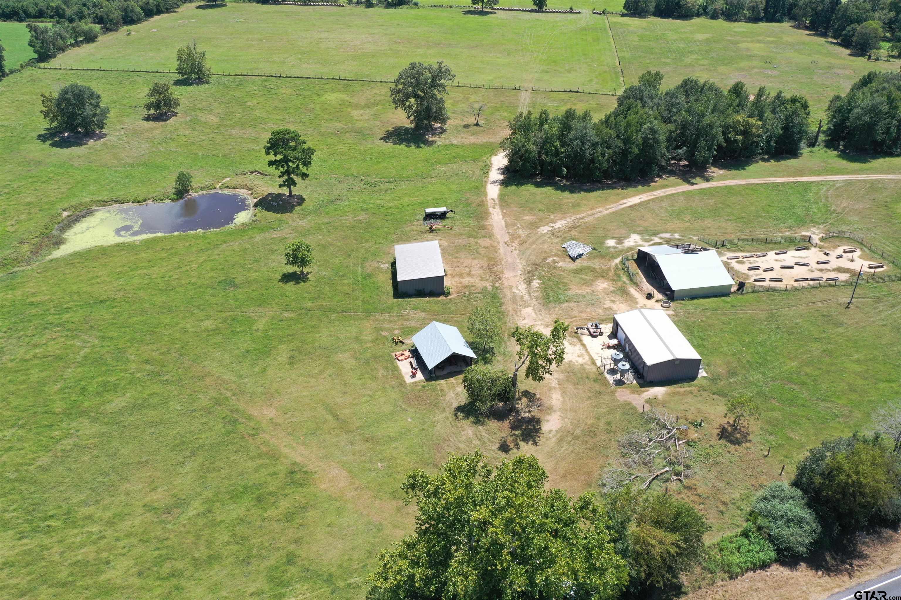 an aerial view of a house with a yard basket ball court and outdoor seating