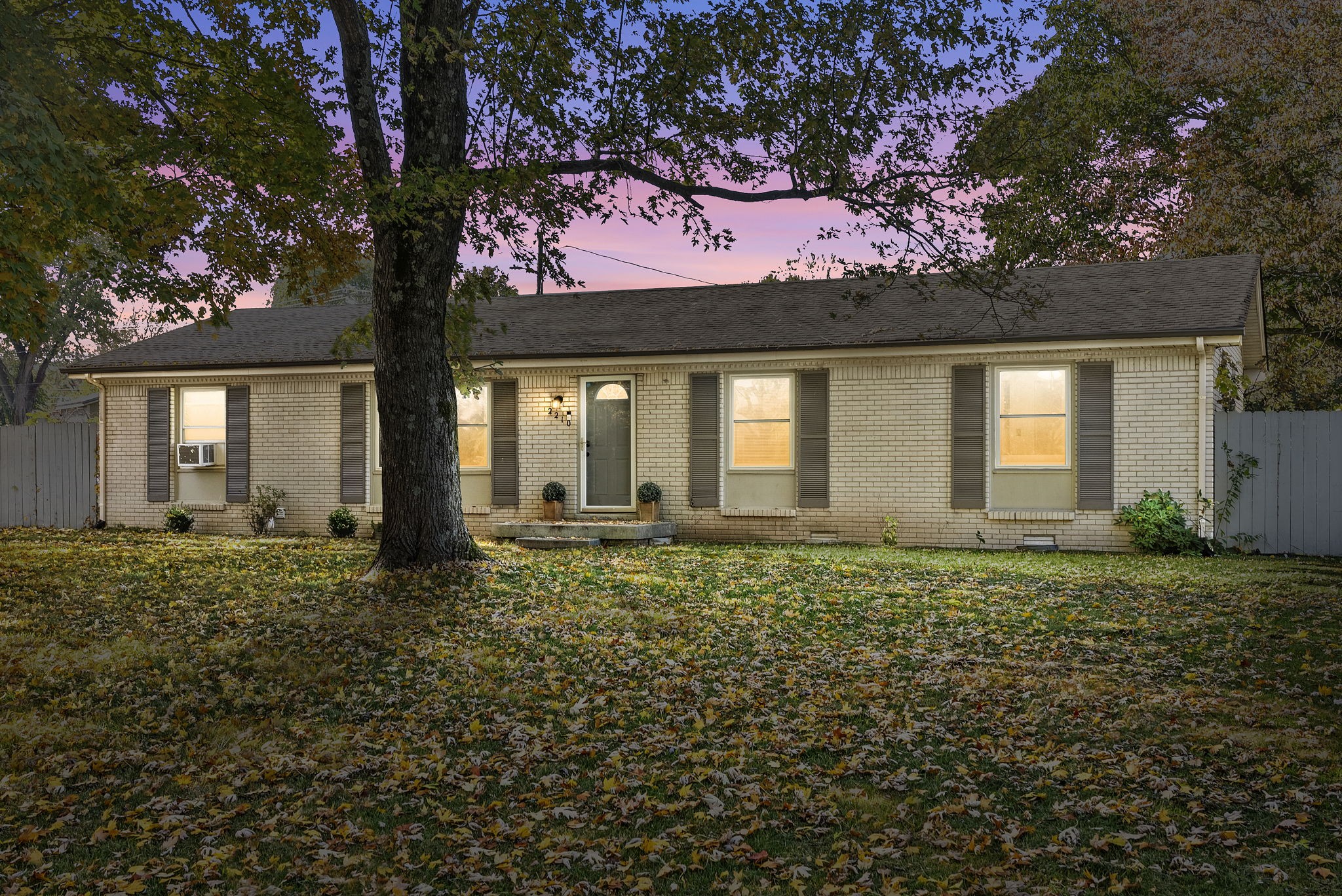 a large tree in front of a house