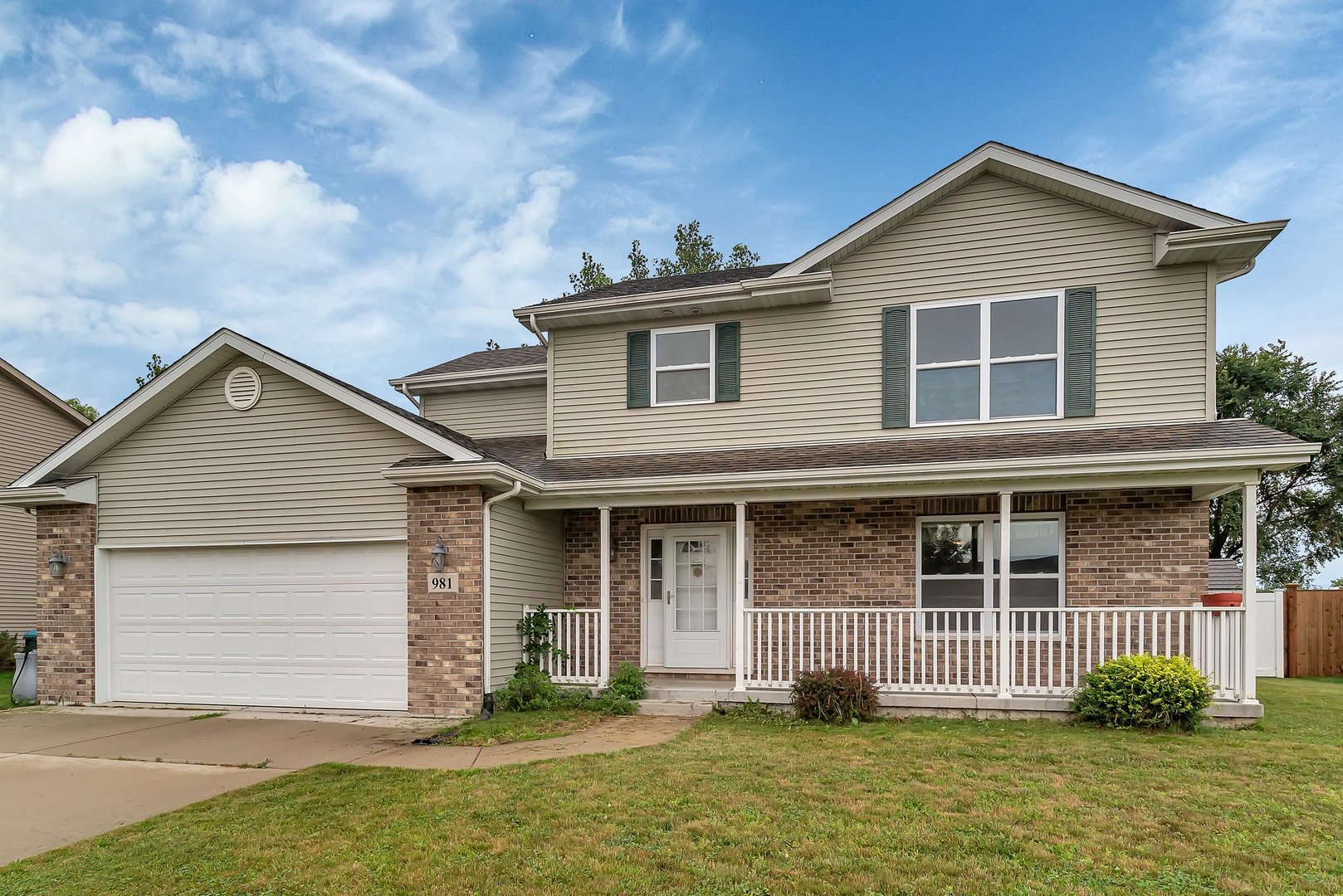 a front view of a house with garage