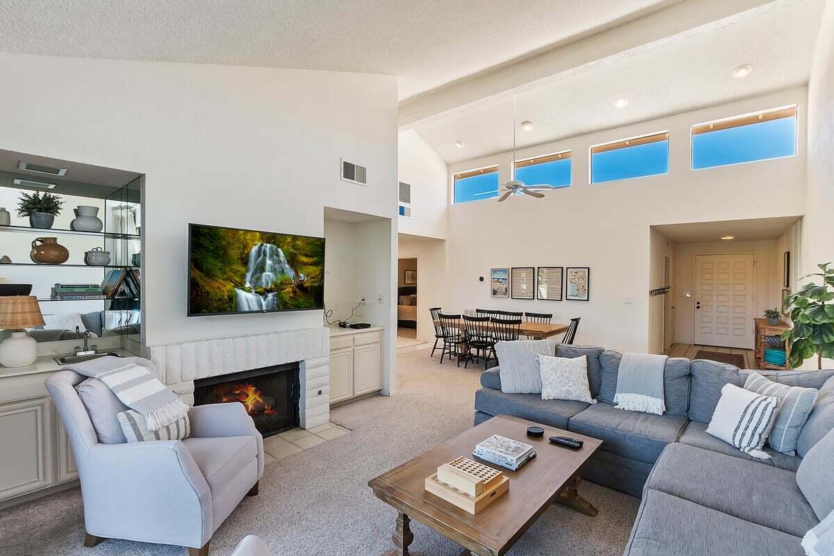 a living room with furniture a fireplace and a flat screen tv