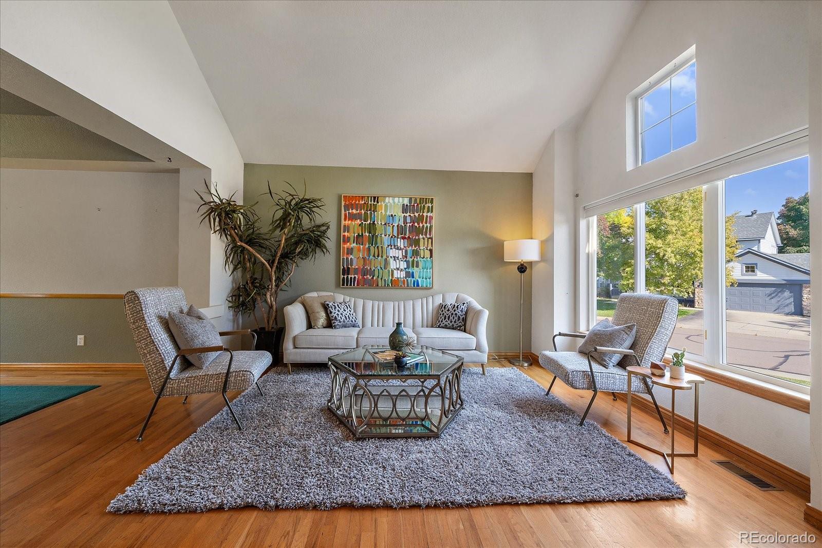 a living room with furniture rug and window