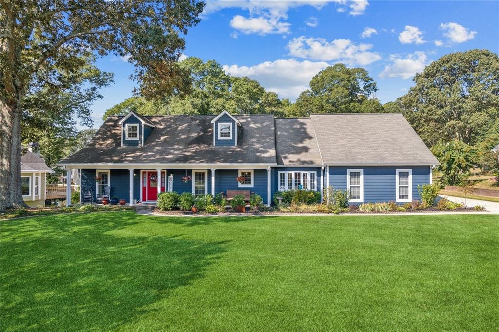 a front view of a house with a garden