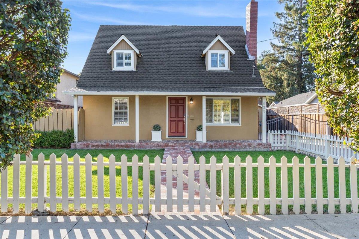 a front view of a house with a garden