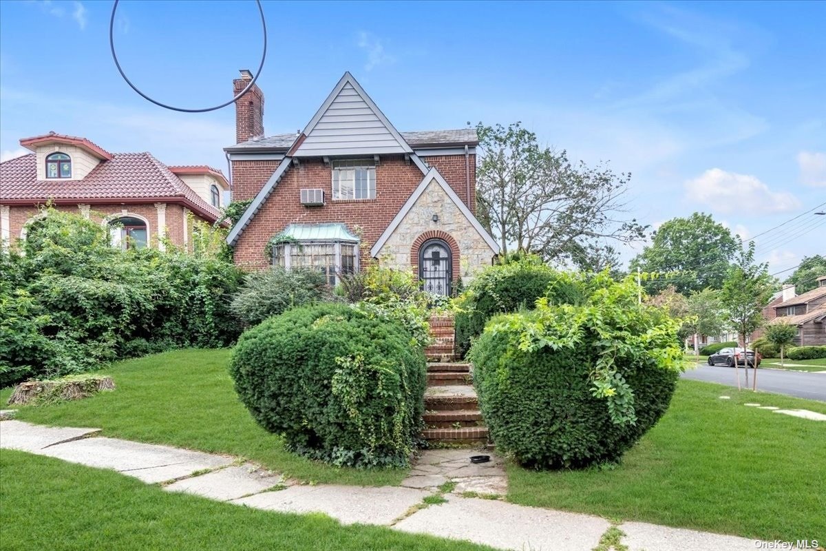 a front view of a house with garden