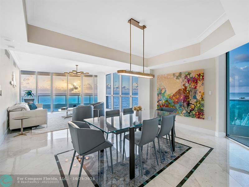 a view of a dining room with furniture wooden floor and a chandelier