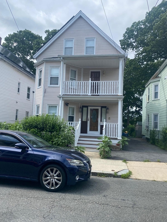 a front view of a house with parking space