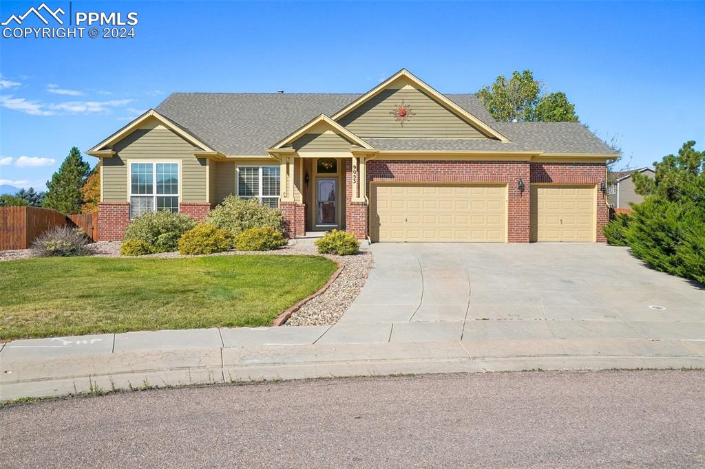 Craftsman-style home featuring a garage and a front lawn