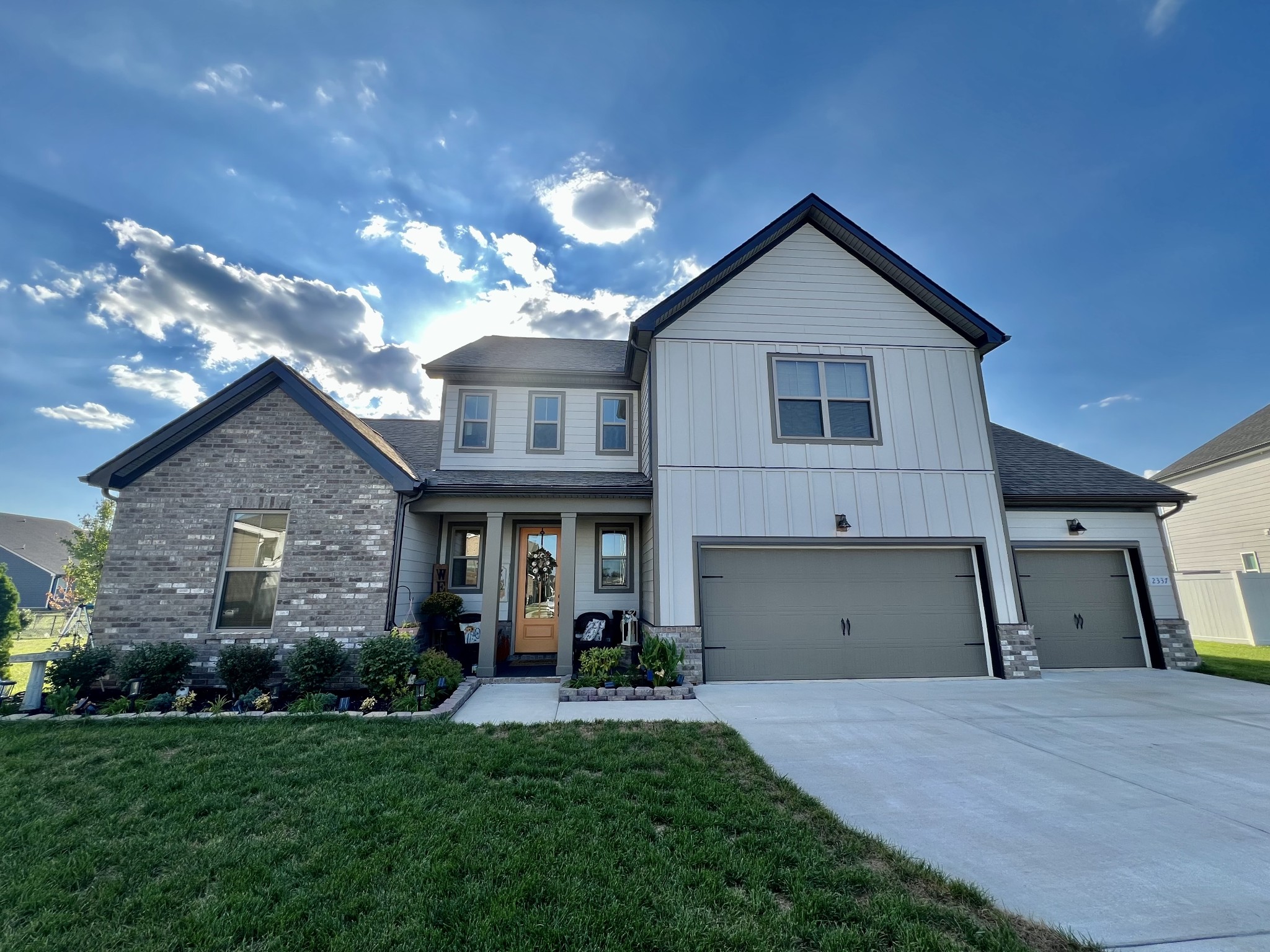 a front view of a house with a yard and garage