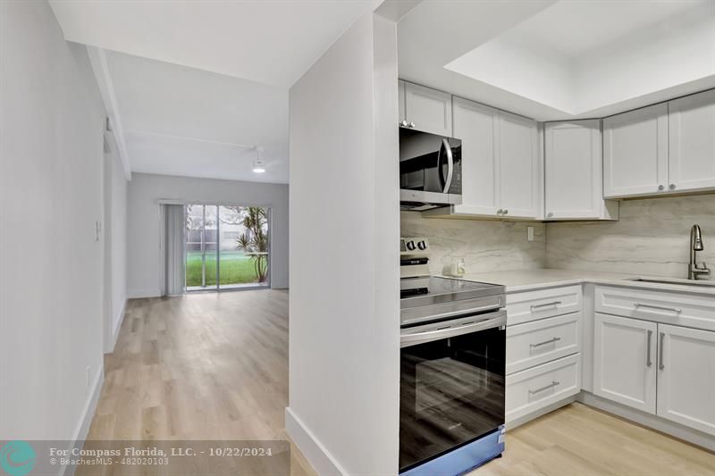 a kitchen with stainless steel appliances granite countertop a stove and a sink